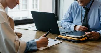 Two People Working At a Table